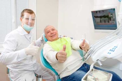 man with dentist preparing for oral surgery