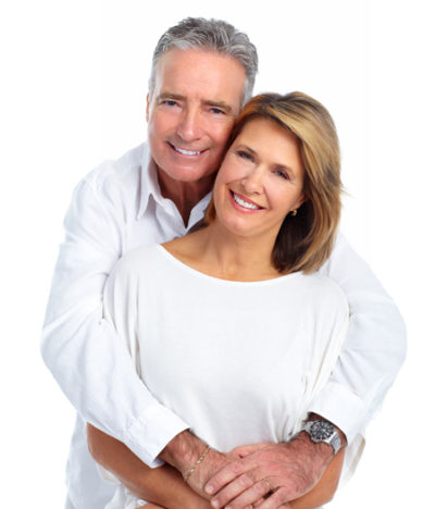 senior couple smiling after getting dental bridges