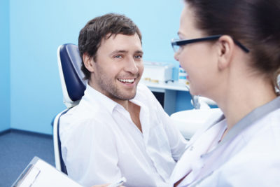 man talking to dentist about dental veneers