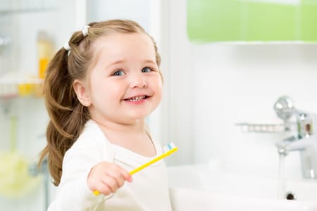 young child smiling after no cavities visit from the dentist