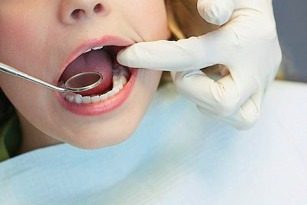 child with dentist getting sealants treatment